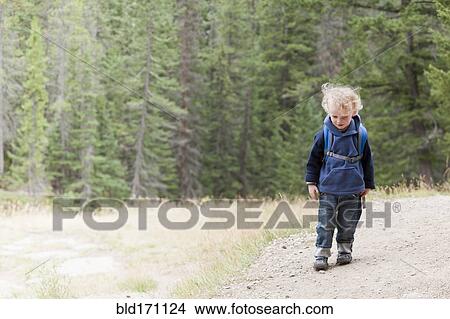 Caucasian boy hiking in forest View Large Photo Image Picture - Caucasian boy hiking in forest. Fotosearch