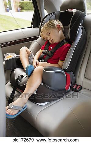 Stock Photo - Caucasian boy napping in car seat. Fotosearch
