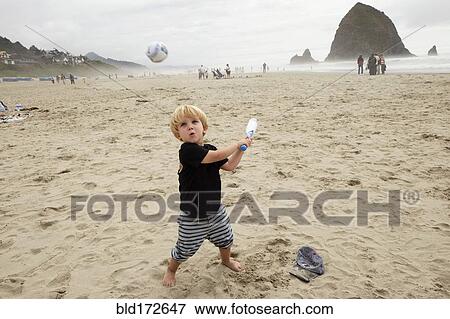 Stock Photo - Caucasian boy playing on beach. Fotosearch