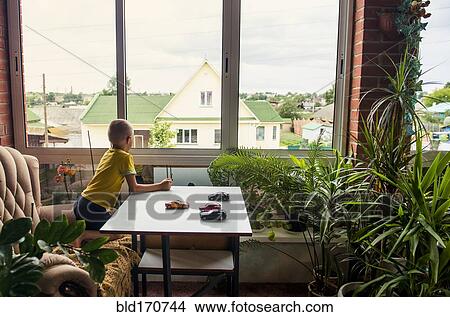 Caucasian boy playing with toy cars at desk View Large Photo Image Picture - Caucasian boy playing with toy cars at desk. Fotosearch