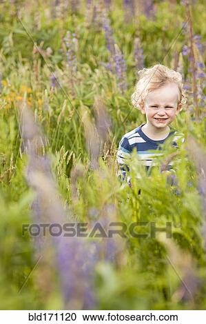 Caucasian boy walking in tall grass View Large Photo Image Stock Image - Caucasian boy walking in tall grass. Fotosearch