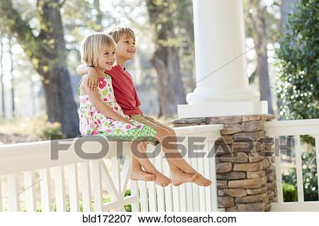 Caucasian brother and sister hugging on patio View Large Photo Image Stock Photo - Caucasian brother and sister hugging on patio. Fotosearch