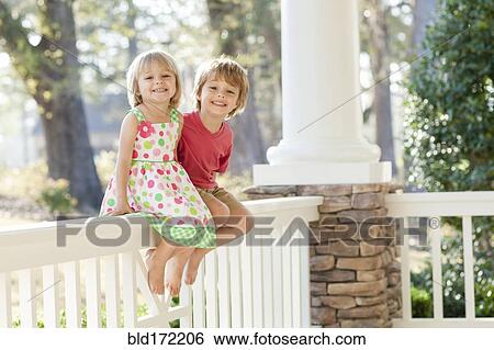 Caucasian brother and sister smiling on patio View Large Photo Image Stock Photograph - Caucasian brother and sister smiling on patio. Fotosearch