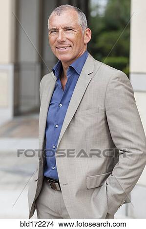 Picture - Caucasian businessman smiling in city. Fotosearch