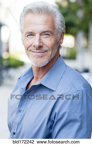 Stock Image - Caucasian businessman smiling outdoors. Fotosearch