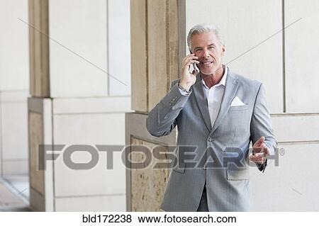 Stock Photo - Caucasian businessman talking on cell phone. Fotosearch