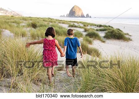 Caucasian children walking on beach View Large Photo Image Stock Image - Caucasian children walking on beach. Fotosearch
