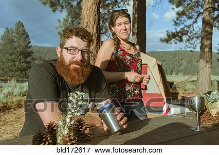 Caucasian couple relaxing at campsite View Large Photo Image Stock Photo - Caucasian couple relaxing at campsite. Fotosearch