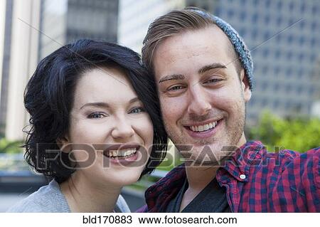Stock Image - Caucasian couple smiling outdoors. Fotosearch