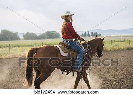 Caucasian cowgirl riding horse on ranch View Large Photo Image Picture - Caucasian cowgirl riding horse on ranch. Fotosearch