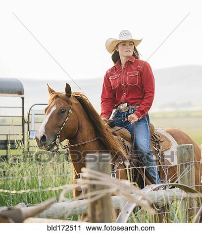 Caucasian cowgirl riding horse on ranch View Large Photo Image Stock Image - Caucasian cowgirl riding horse on ranch. Fotosearch