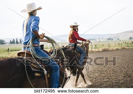 Caucasian cowgirls riding horses on ranch View Large Photo Image Stock Photography - Caucasian cowgirls riding horses on ranch. Fotosearch