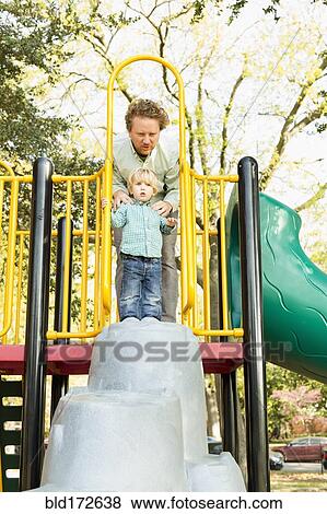 Caucasian father and son playing on play structure View Large Photo Image Stock Photo - Caucasian father and son playing on play structure. Fotosearch