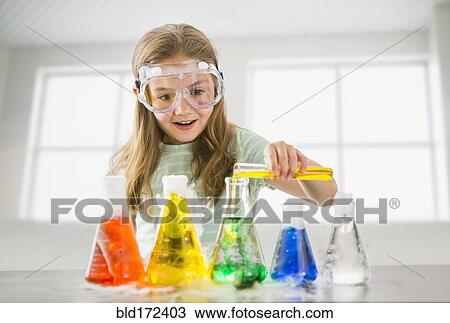 Stock Image - Caucasian girl doing science experiment . Fotosearch