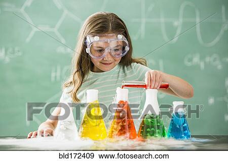Stock Photo - Caucasian girl doing science experiment in classroom. Fotosearch