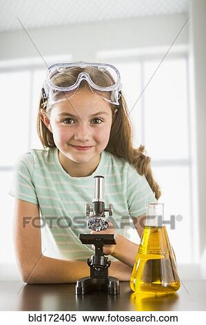 Stock Photography - Caucasian girl doing science experiment . Fotosearch