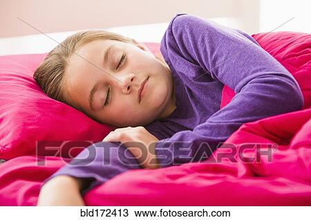 Stock Image - Caucasian girl sleeping in bed. Fotosearch
