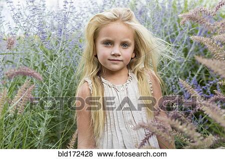 Caucasian girl standing in tall flowers View Large Photo Image Stock Photo - Caucasian girl standing in tall flowers. Fotosearch