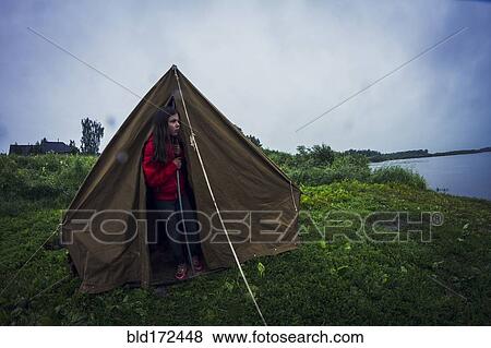 Caucasian girl standing in tent at campsite View Large Photo Image Stock Photo - Caucasian girl standing in tent at campsite. Fotosearch