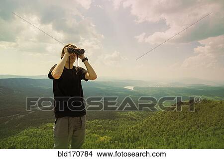 Picture - Caucasian hiker admiring remote landscape. Fotosearch