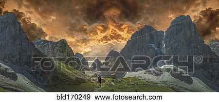 Caucasian hiker walking by remote mountains, Dolomites, Trento Alto Adige, Italy View Large Photo Image Stock Photo - Caucasian hiker walking by remote mountains, Dolomites, Trento Alto Adige, Italy. Fotosearch