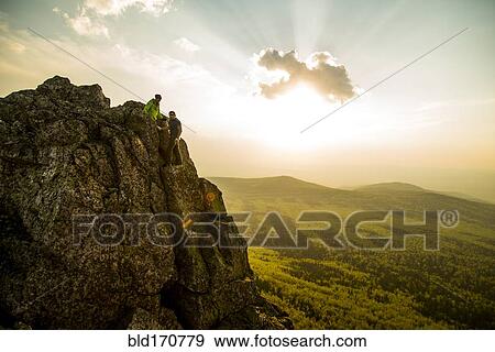 Caucasian hikers on rocky hilltop in remote landscape View Large Photo Image Stock Photo - Caucasian hikers on rocky hilltop in remote landscape. Fotosearch