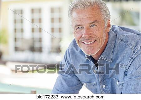 Caucasian man leaning on counter View Large Photo Image Stock Image - Caucasian man leaning on counter. Fotosearch