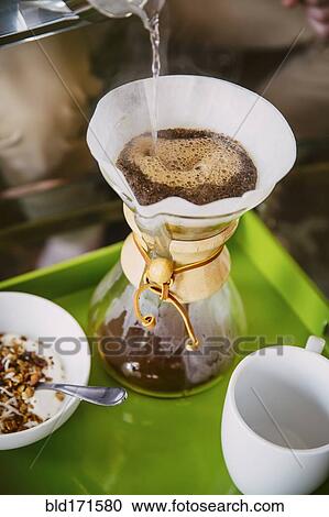 Stock Image - Caucasian man pouring breakfast coffee. Fotosearch