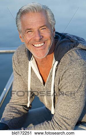 Caucasian man smiling on boat deck View Large Photo Image Stock Image - Caucasian man smiling on boat deck. Fotosearch
