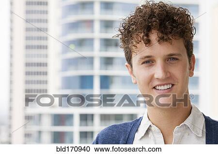 Caucasian man smiling on urban balcony View Large Photo Image Stock Image - Caucasian man smiling on urban balcony. Fotosearch