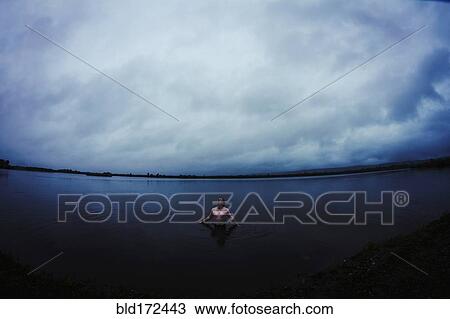 Caucasian man standing in still remote lake View Large Photo Image Stock Image - Caucasian man standing in still remote lake. Fotosearch