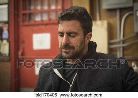 Stock Photograph - Caucasian man thinking in warehouse. Fotosearch