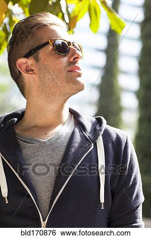 Caucasian man wearing sunglasses outdoors View Large Photo Image Stock Photograph - Caucasian man wearing sunglasses outdoors. Fotosearch