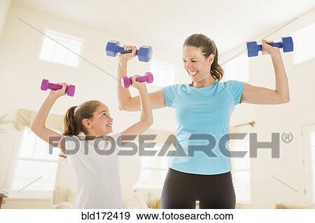 Caucasian mother and daughter lifting weights View Large Photo Image Stock Photo - Caucasian mother and daughter lifting weights. Fotosearch