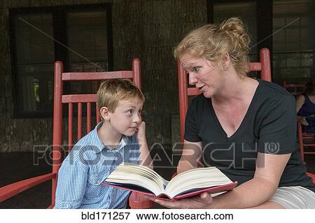 Caucasian mother and son reading on patio View Large Photo Image Stock Photo - Caucasian mother and son reading on patio. Fotosearch