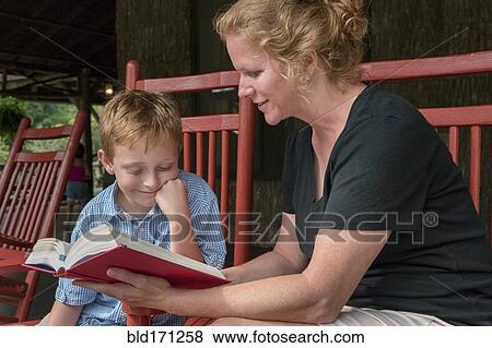 Caucasian mother and son reading on patio View Large Photo Image Stock Photo - Caucasian mother and son reading on patio. Fotosearch