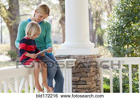 Caucasian mother and son talking on patio View Large Photo Image Stock Photograph - Caucasian mother and son talking on patio. Fotosearch