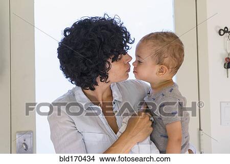 Caucasian mother kissing baby son View Large Photo Image Picture - Caucasian mother kissing baby son. Fotosearch