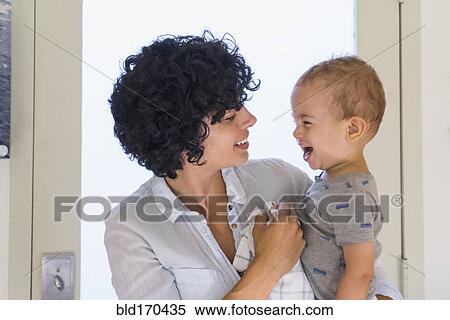 Caucasian mother kissing baby son View Large Photo Image Stock Photography - Caucasian mother kissing baby son. Fotosearch