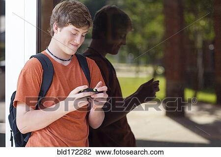 Caucasian teenage boy using cell phone View Large Photo Image Stock Image - Caucasian teenage boy using cell phone. Fotosearch