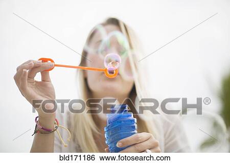 Caucasian woman blowing bubbles outdoors View Large Photo Image Stock Photograph - Caucasian woman blowing bubbles outdoors. Fotosearch