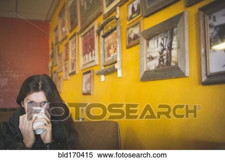 Caucasian woman drinking coffee in cafe View Large Photo Image Stock Photography - Caucasian woman drinking coffee in cafe. Fotosearch