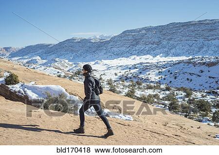 Caucasian woman hiking on remote hillside View Large Photo Image Stock Photo - Caucasian woman hiking on remote hillside. Fotosearch
