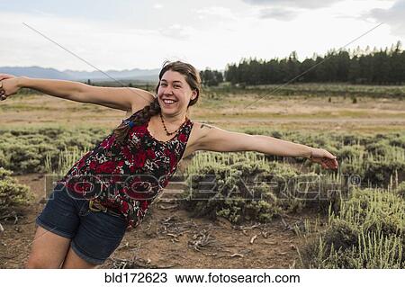 Stock Image - Caucasian woman posing in remote field. Fotosearch
