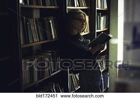 Caucasian woman reading book in library View Large Photo Image Stock Image - Caucasian woman reading book in library. Fotosearch