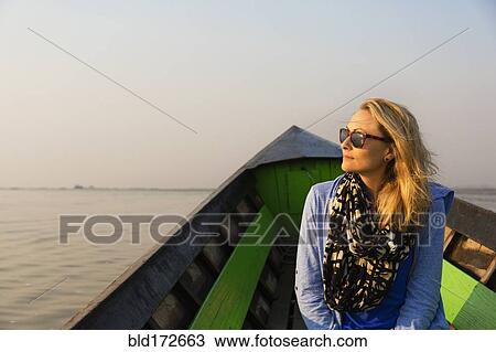 Caucasian woman riding in canoe on rural lake View Large Photo Image Stock Image - Caucasian woman riding in canoe on rural lake. Fotosearch