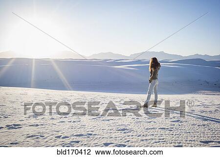 Stock Image - Caucasian woman standing in White Sands National Park, New Mexico, United States. Fotosearch