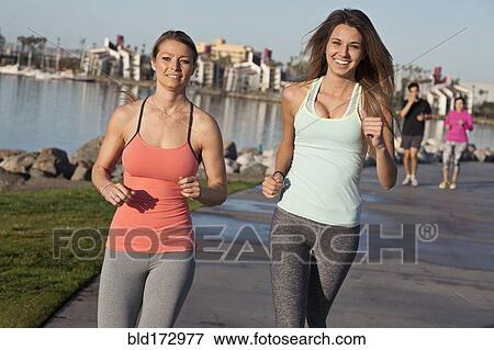 Caucasian women jogging at waterfront View Large Photo Image Stock Photo - Caucasian women jogging at waterfront. Fotosearch