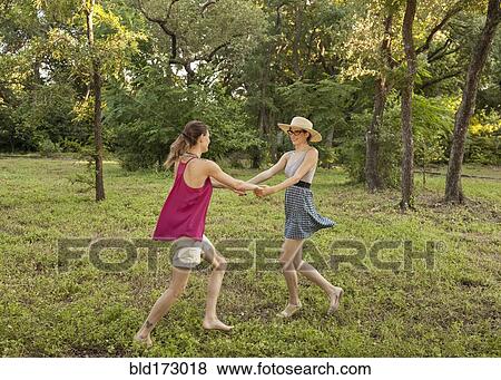 Stock Photo - Caucasian women playing in park. Fotosearch