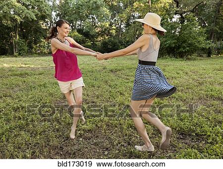 Stock Photo - Caucasian women playing in park. Fotosearch